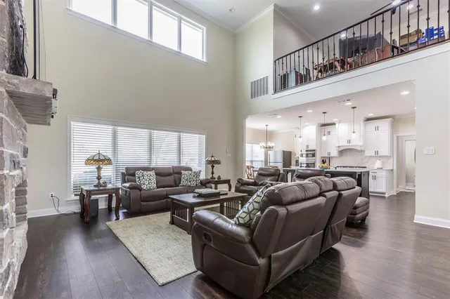 a living room with furniture wooden floor and a large window