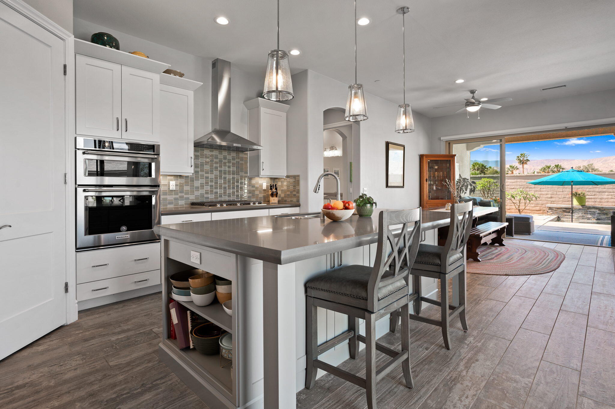 49 Cabernet Rancho Mirage, CA 92270 - Photo 11 of 40 a kitchen with stainless steel appliances a dining table chairs stove and cabinets