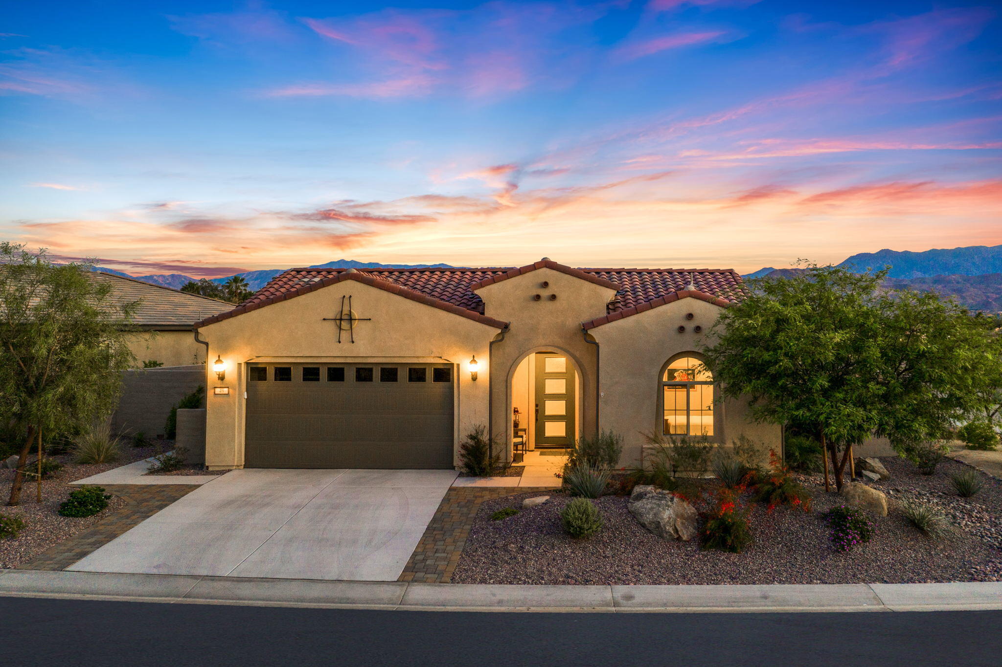 49 Cabernet Rancho Mirage, CA 92270 - Photo 2 of 40 a view of a big house with large windows and a yard