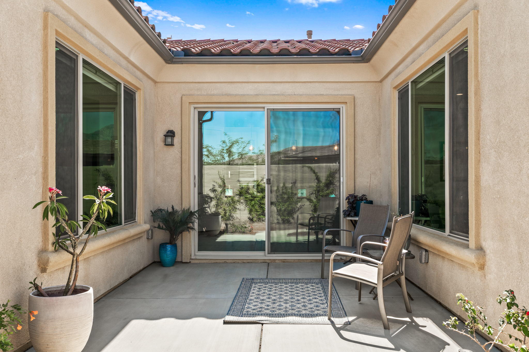 49 Cabernet Rancho Mirage, CA 92270 - Photo 32 of 40 a view of a patio with couple of chairs and a potted plant