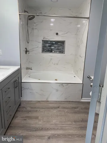 a bathroom with a bathtub and a shower
