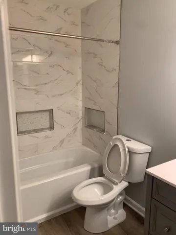 a bathroom with a toilet and a shower