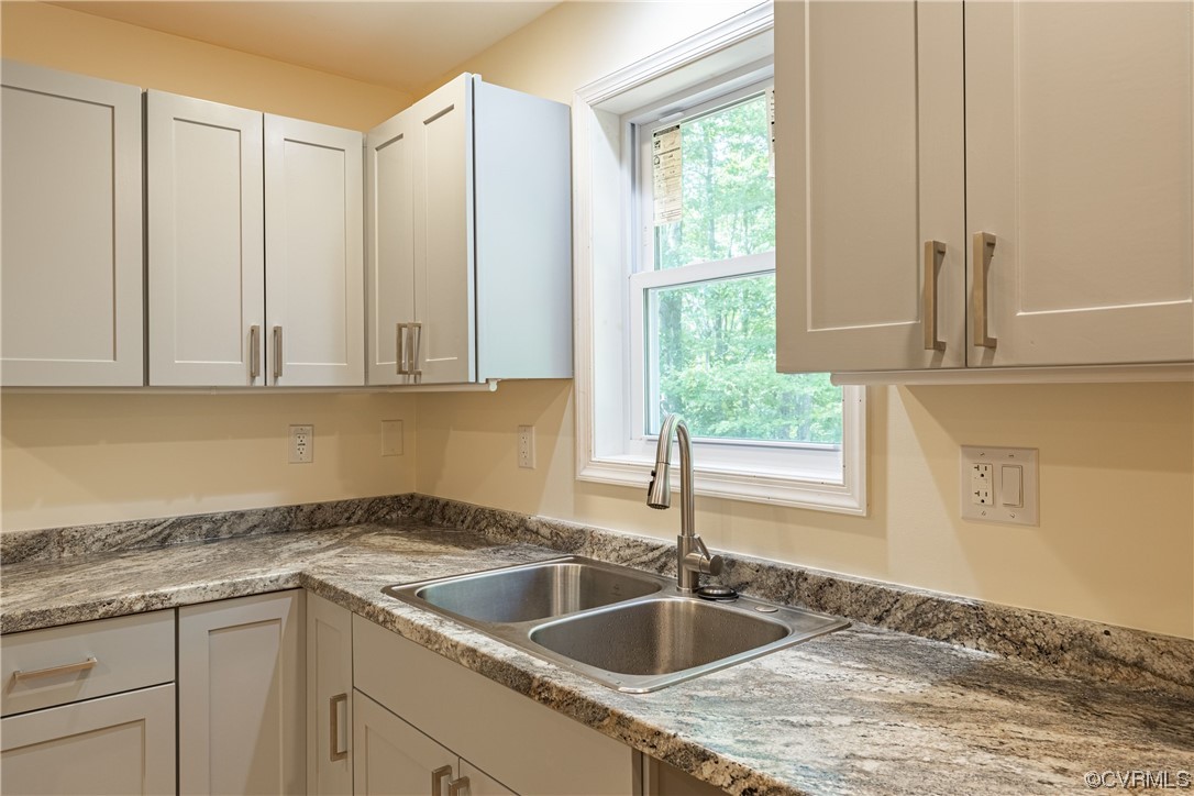 363 Oak Hill Road Prospect, VA 23960 - Photo 13 of 33 a kitchen with granite countertop a sink and white cabinets