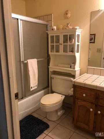a bathroom with a toilet a sink and shower