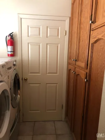 a view of a storage & utility room with dryer and washer