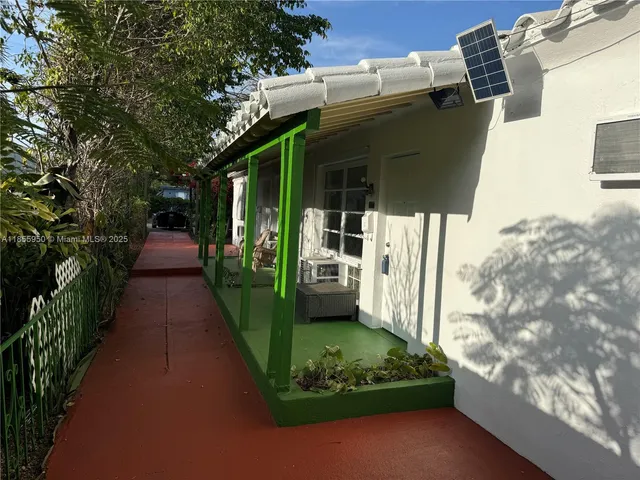 a view of a pathway of a house with a yard