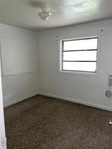 an empty room with a empty space and window