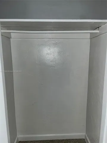 a view of a livingroom with a white car parked