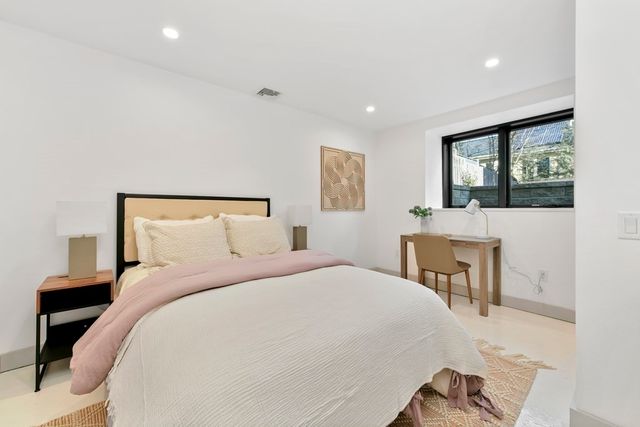 a bedroom with a bed and a table in it