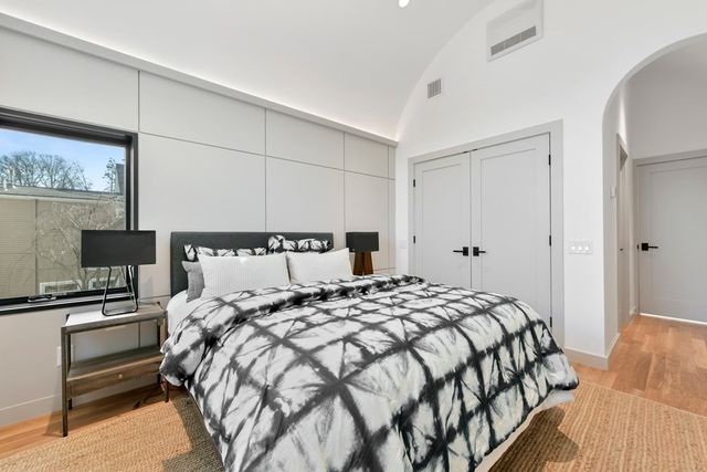 a bedroom with a bed and a tv on the dresser