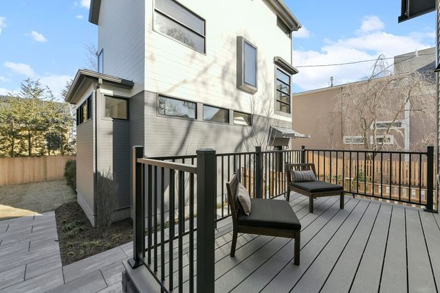 a view of a balcony with wooden floor and fence