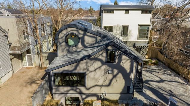 a view of a house with a large tree