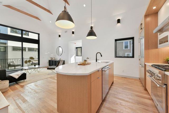 a large kitchen with stainless steel appliances a lot of counter space