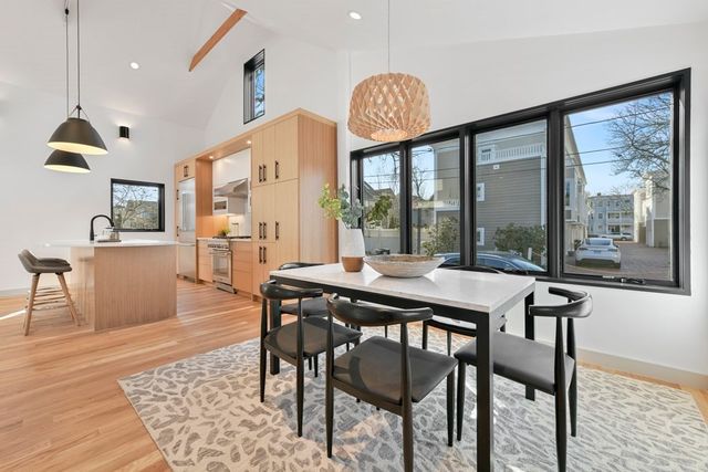 a dining room with furniture a chandelier and wooden floor