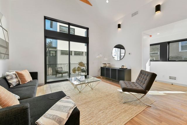 a living room with furniture and a floor to ceiling window