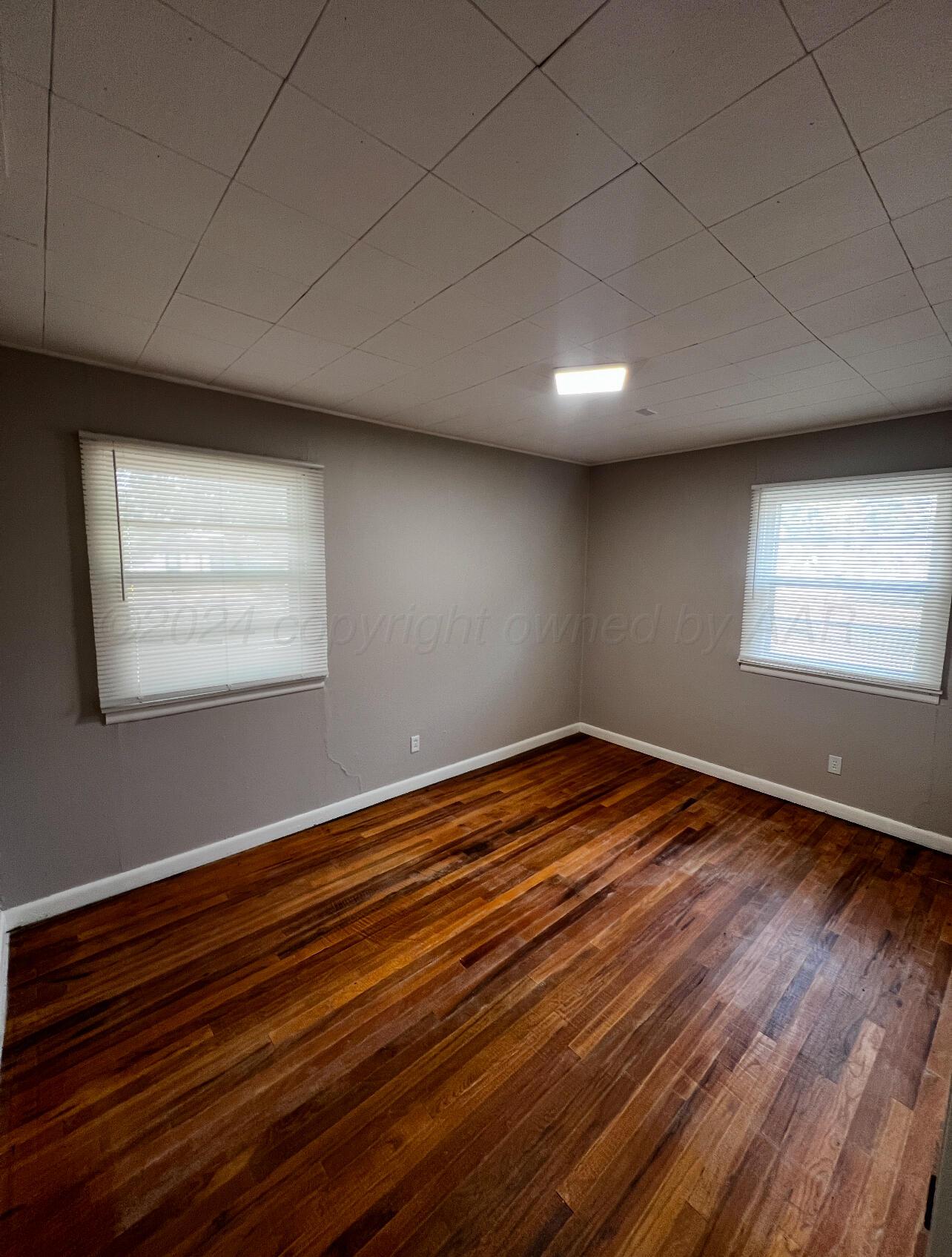 403 Cherry Street Claude, TX 79019 - Photo 24 of 110 a view of empty room with wooden floor and fan