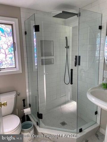 347 Highway 35 Mantoloking, NJ 08738 - Photo 9 of 9 Sleek glass shower with vibrant window accents.