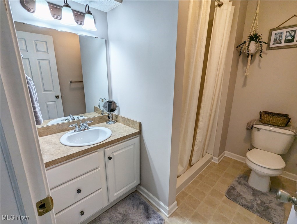37625 Sandy Ridge Drive North Ridgeville, OH 44039 - Photo 34 of 44 Bathroom with a shower with shower curtain, vanity, toilet, and tile patterned flooring