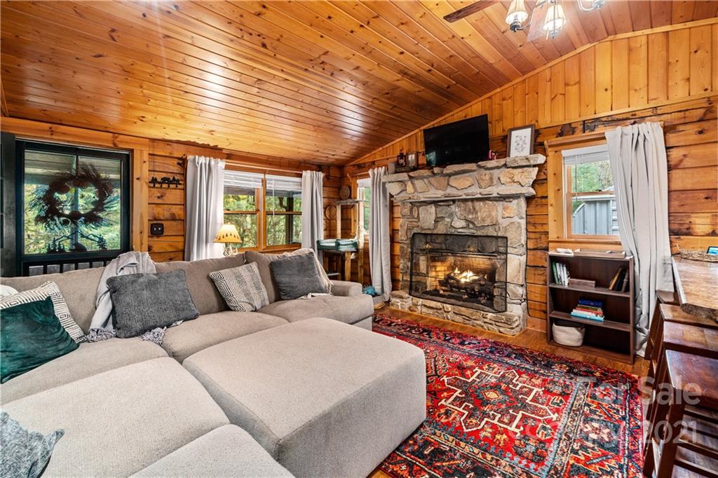 146 Spring Drive Maggie Valley, NC 28751 - Photo 1 of 36 a living room with furniture a fireplace and a table