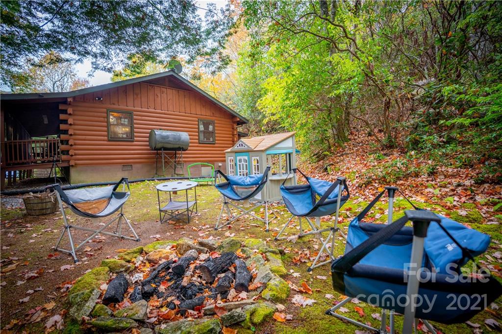 146 Spring Drive Maggie Valley, NC 28751 - Photo 19 of 36 a view of a chairs and table in backyard