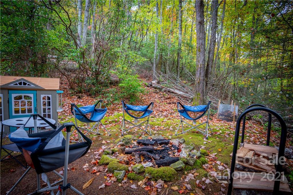 146 Spring Drive Maggie Valley, NC 28751 - Photo 26 of 36 a backyard of a house with table and chairs
