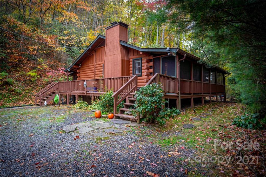 146 Spring Drive Maggie Valley, NC 28751 - Photo 3 of 36 a view of a house with a yard and large trees