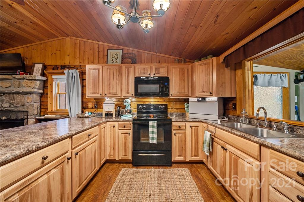 146 Spring Drive Maggie Valley, NC 28751 - Photo 6 of 36 a kitchen with stainless steel appliances granite countertop a stove a sink dishwasher and a microwave oven with granite countertops