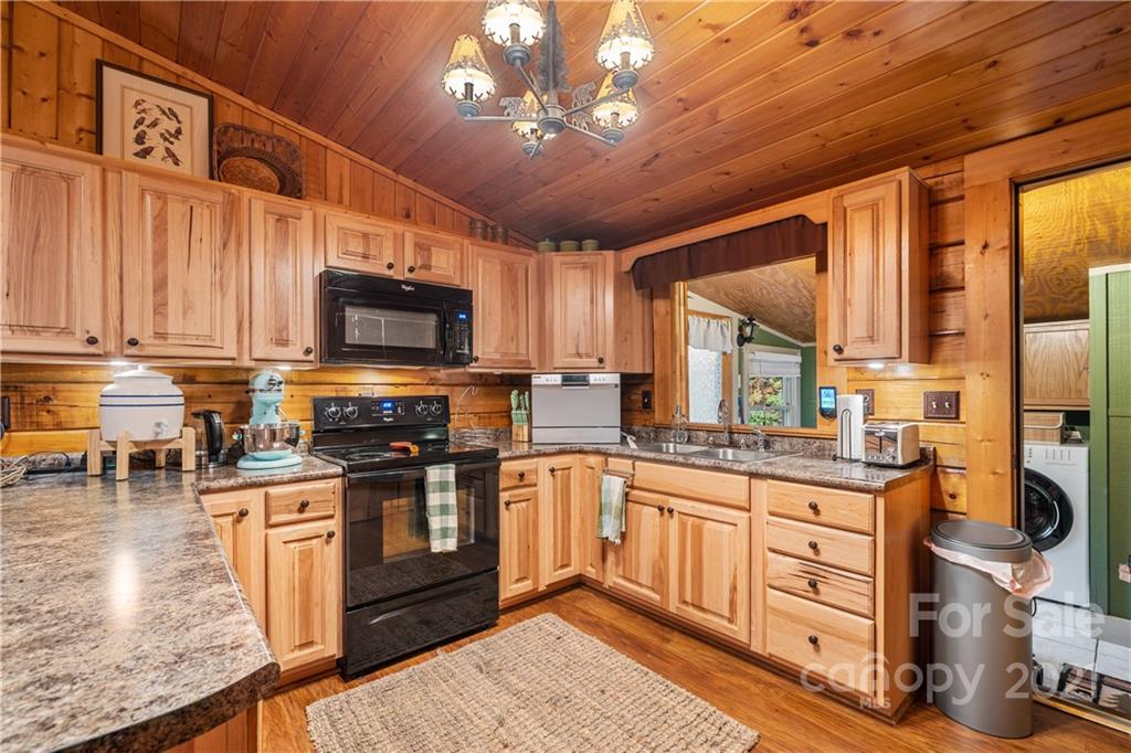 146 Spring Drive Maggie Valley, NC 28751 - Photo 8 of 36 a kitchen with stainless steel appliances granite countertop a stove sink and cabinets