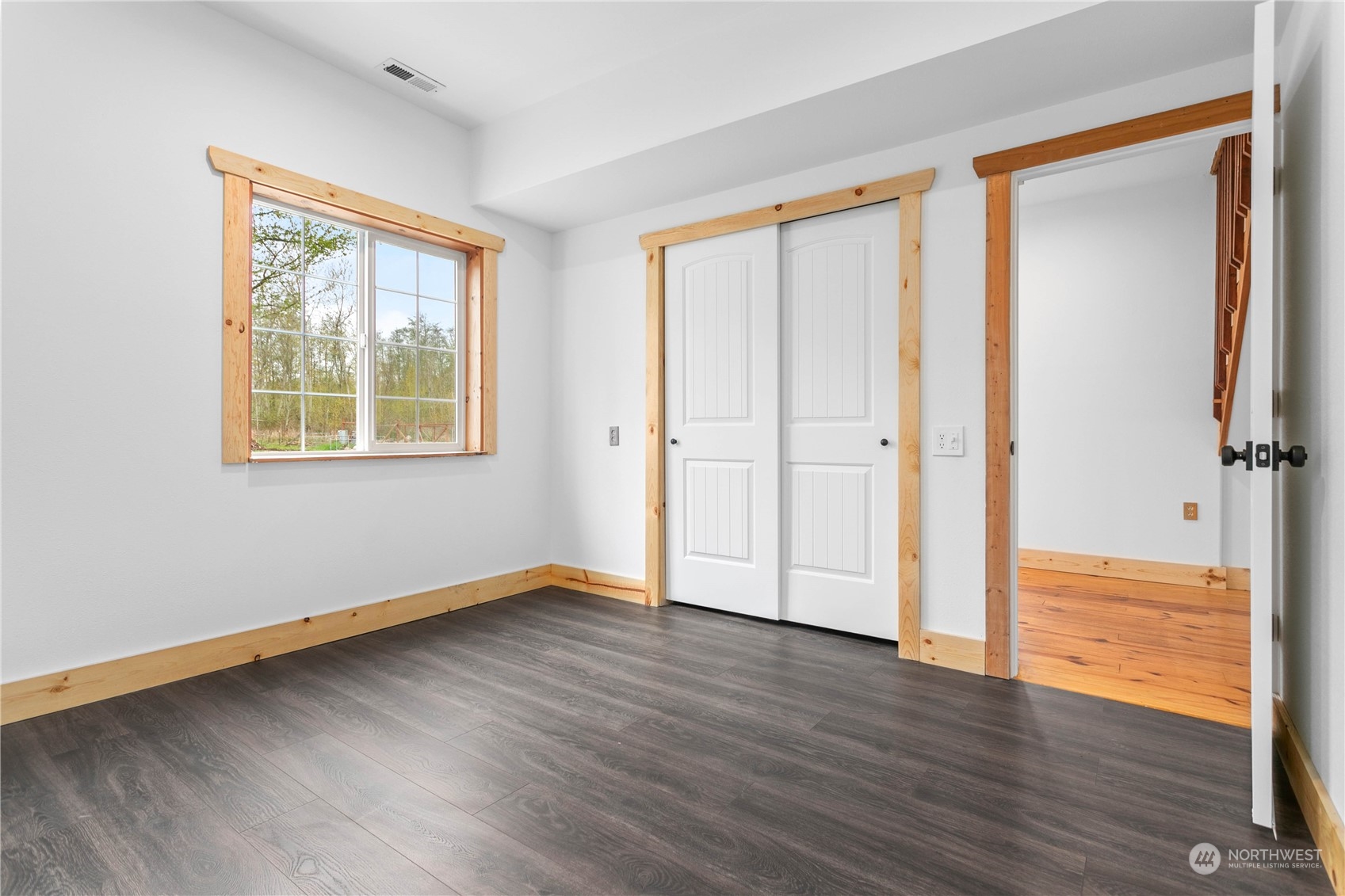 3900 Bay Road Ferndale, WA 98248 - Photo 18 of 40 an empty room with wooden floor and windows