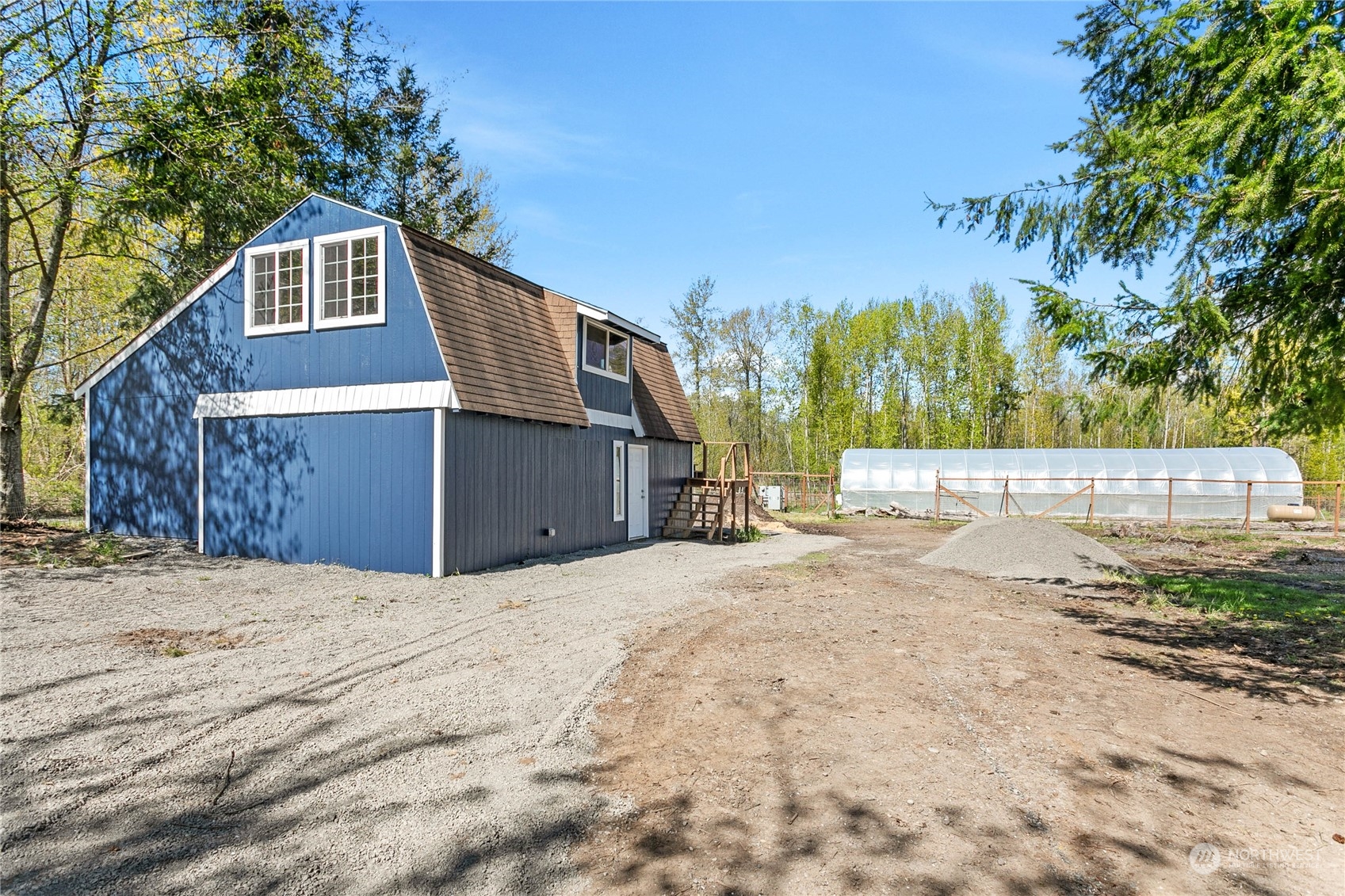 3900 Bay Road Ferndale, WA 98248 - Photo 29 of 40 a side view of a house with a yard and garage
