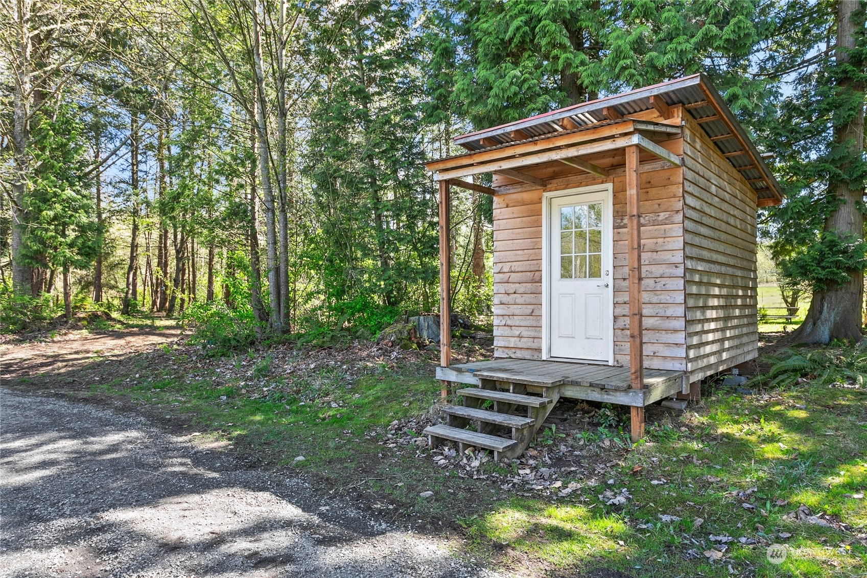 3900 Bay Road Ferndale, WA 98248 - Photo 33 of 40 a small house with a tree in the yard