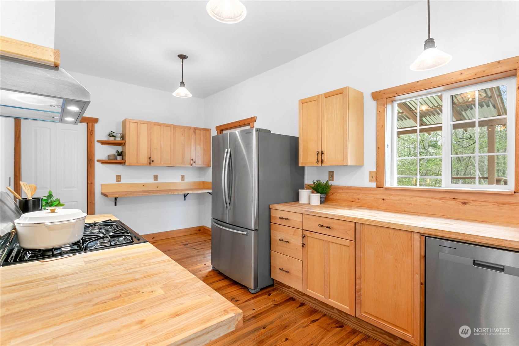3900 Bay Road Ferndale, WA 98248 - Photo 6 of 40 a kitchen with a refrigerator a stove a sink dishwasher and wooden cabinets with wooden floor