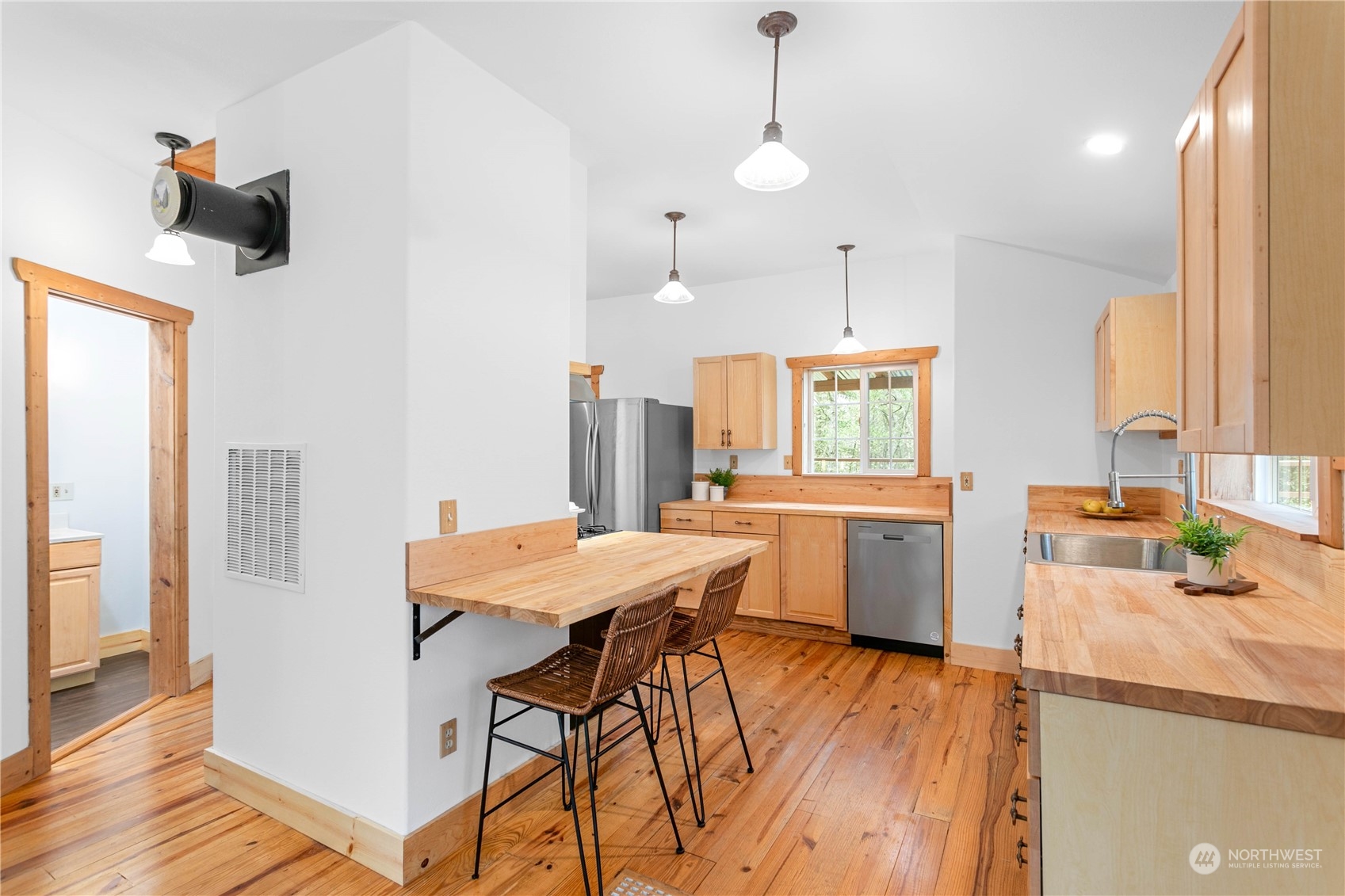 3900 Bay Road Ferndale, WA 98248 - Photo 8 of 40 a kitchen with a table chairs refrigerator and microwave