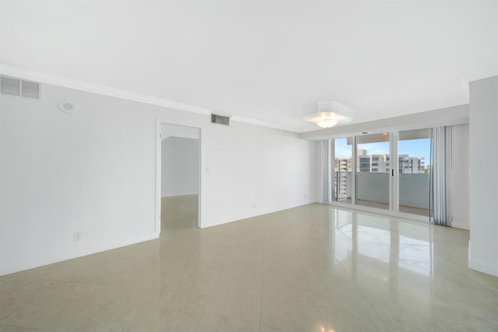 1360 South Ocean Boulevard, Unit 905 Pompano Beach, FL 33062 - Photo 19 of 57 a view of an empty room with wooden floor and a window