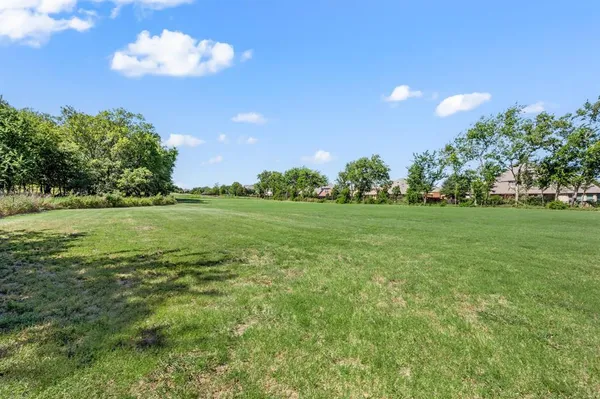 a view of a golf course with a big yard
