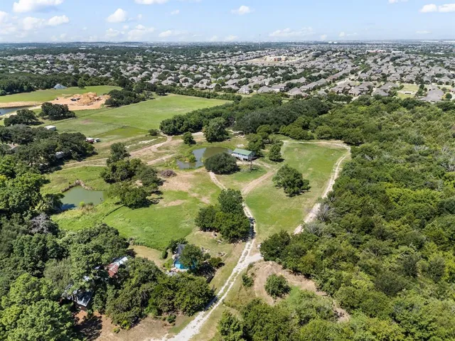 an aerial view of residential houses with outdoor space