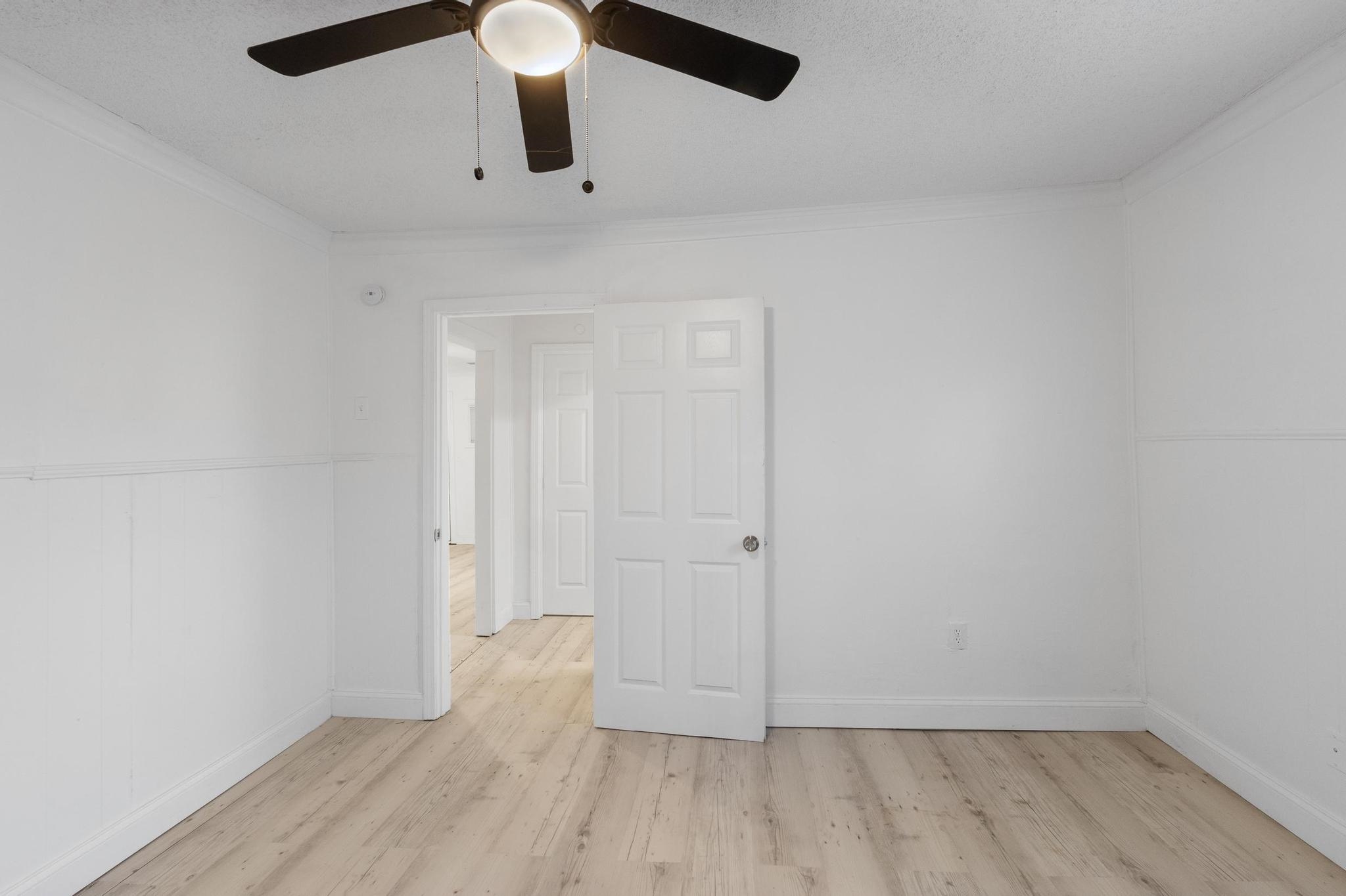 3726 Mart Road Memphis, TN 38109 - Photo 17 of 33 an empty room with wooden floor cabinets and entryway
