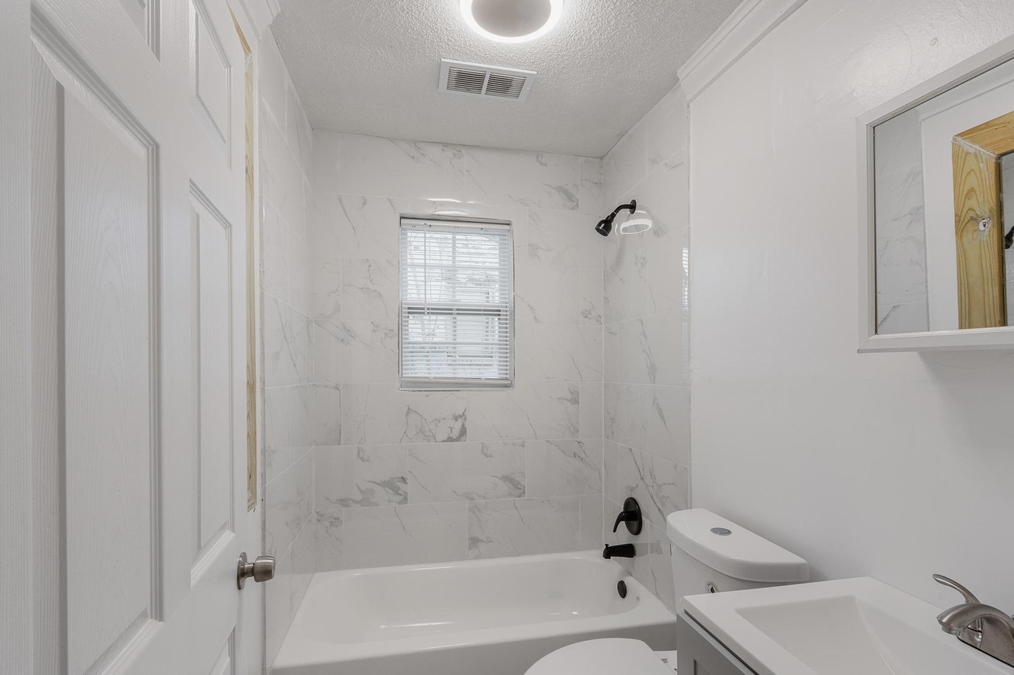3726 Mart Road Memphis, TN 38109 - Photo 27 of 33 a bathroom with a bathtub and shower
