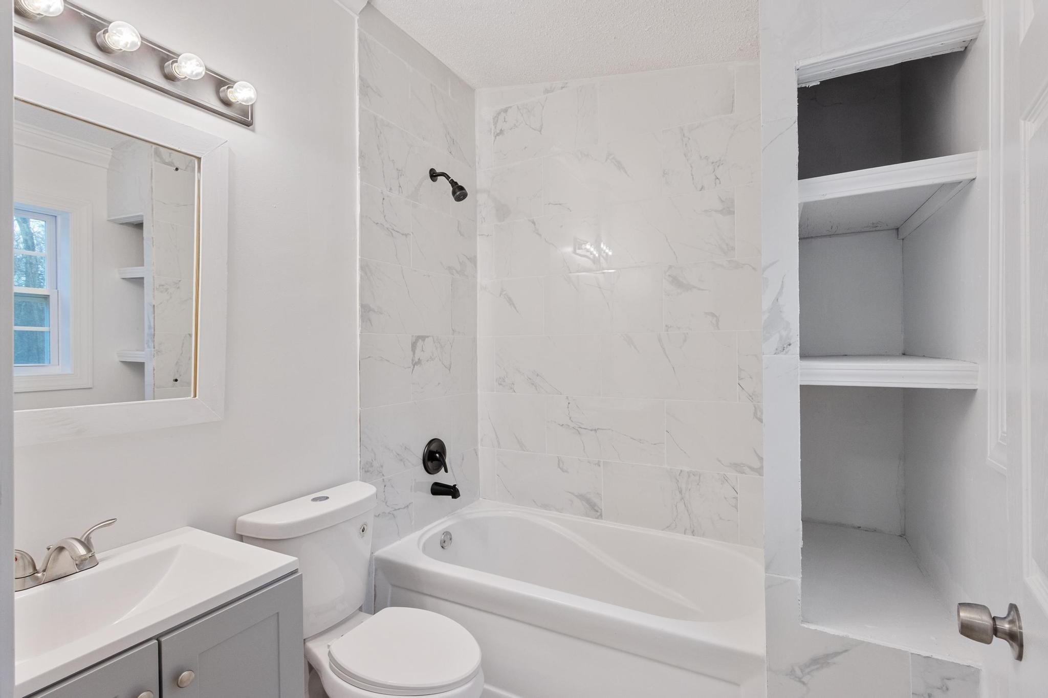 3726 Mart Road Memphis, TN 38109 - Photo 29 of 33 a bathroom with a toilet and a bathtub