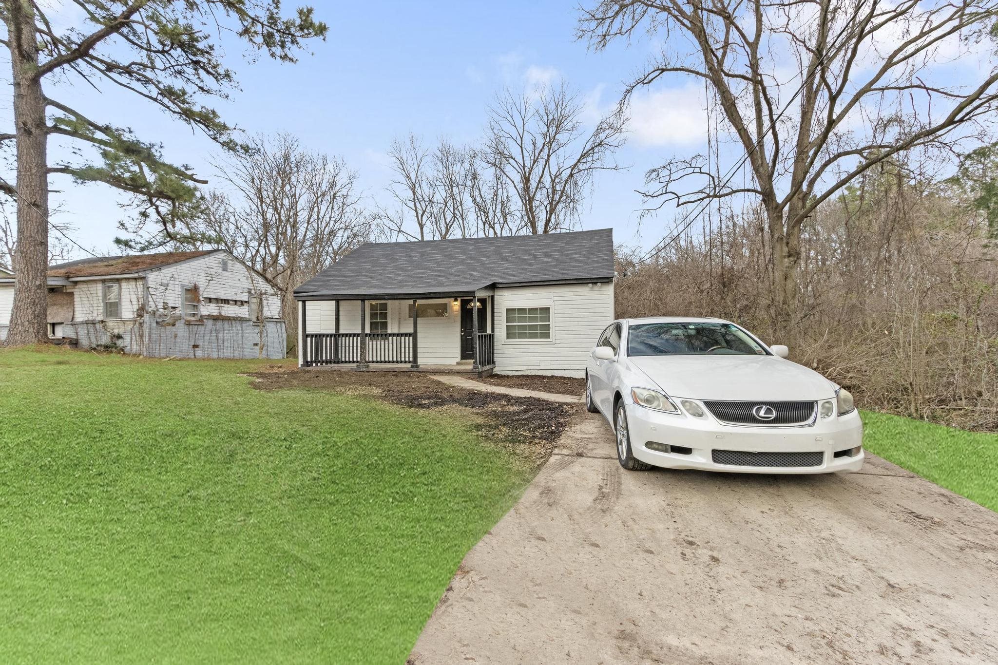 3726 Mart Road Memphis, TN 38109 - Photo 7 of 33 a car parked in front of a house with a yard