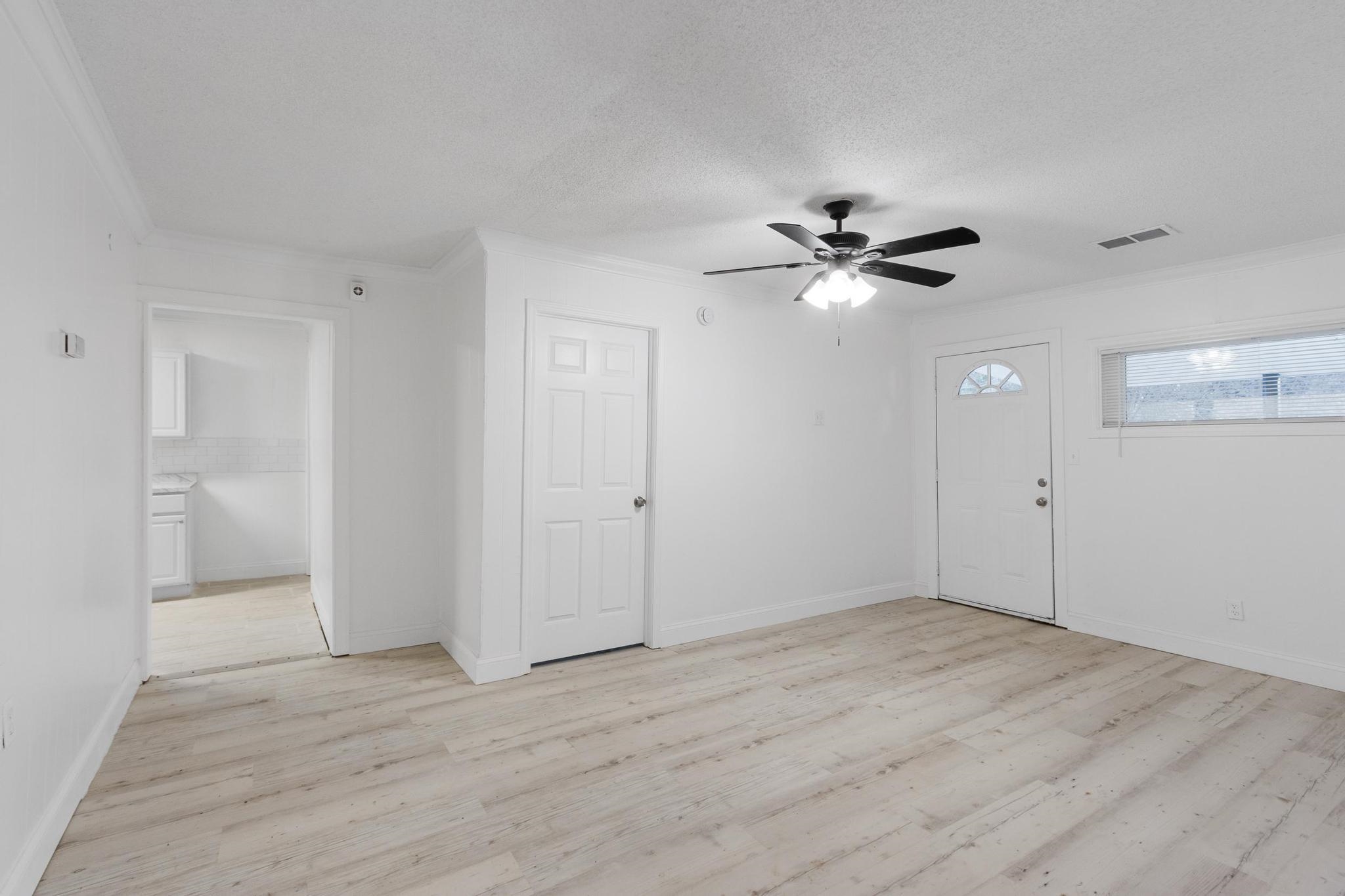 3726 Mart Road Memphis, TN 38109 - Photo 10 of 33 wooden floor in an empty room with a ceiling fan