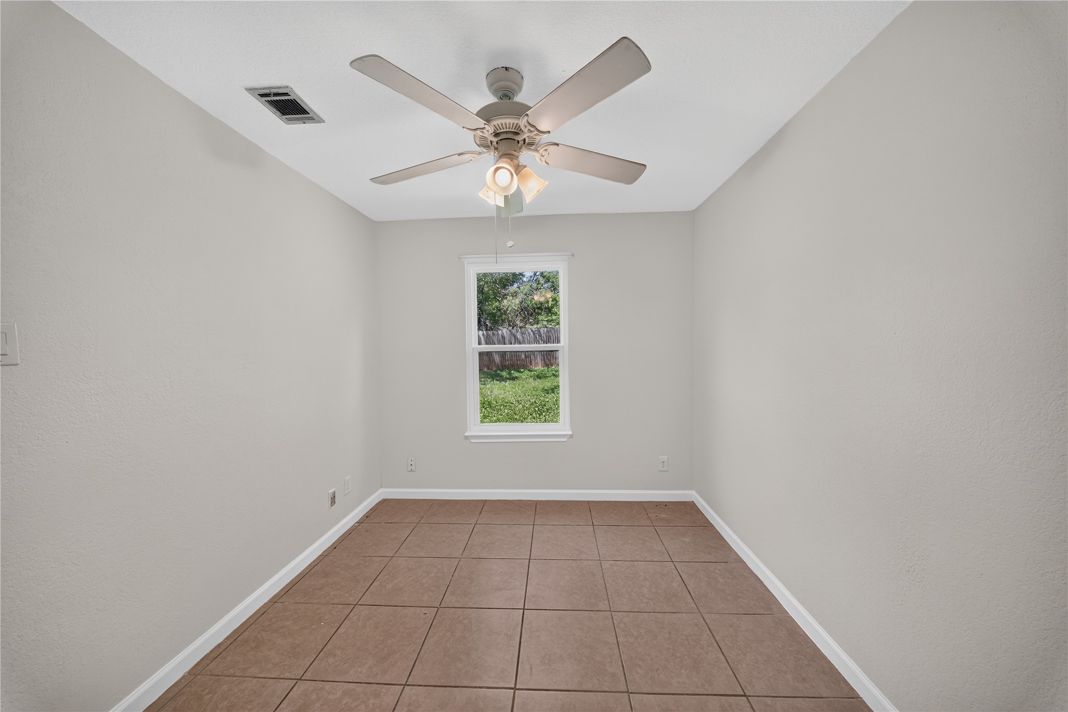 339 Fantail Loop, Unit B Austin, TX 78734 - Photo 18 of 21 an empty room with windows and fan