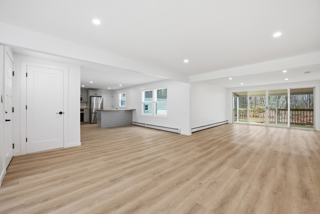 309 Pleasant Street Paxton, MA 01612 - Photo 11 of 27 a view of a big room with wooden floor and windows