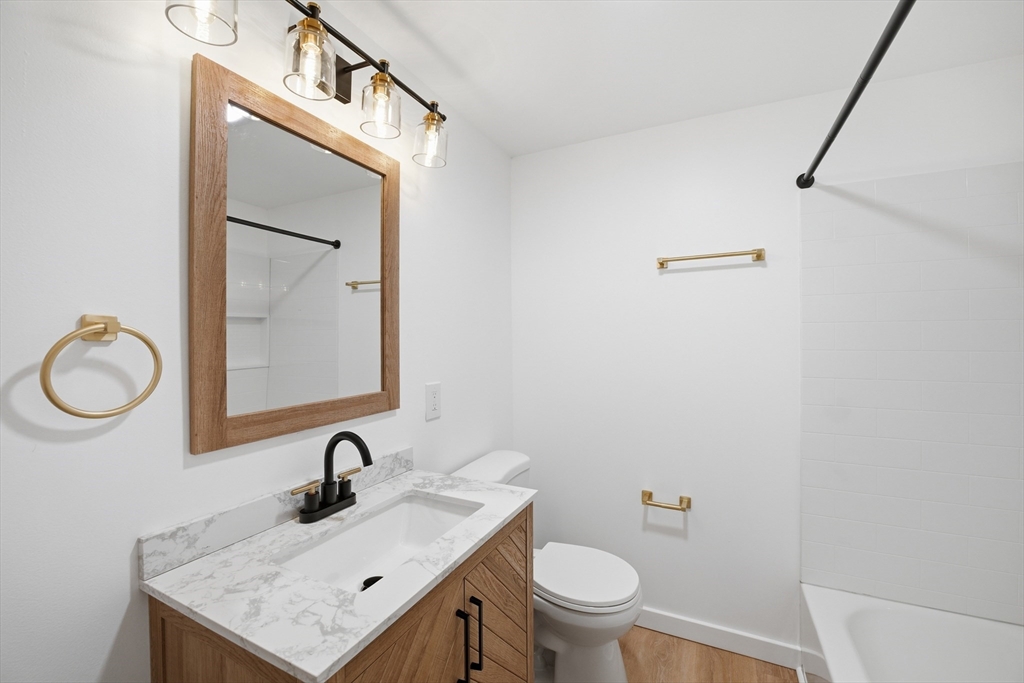 309 Pleasant Street Paxton, MA 01612 - Photo 14 of 27 a bathroom with a granite countertop sink vanity mirror and toilet