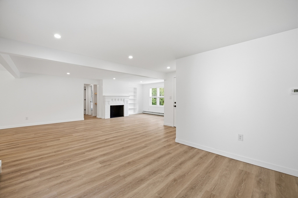 309 Pleasant Street Paxton, MA 01612 - Photo 16 of 27 a view of a livingroom with wooden floor and fireplace