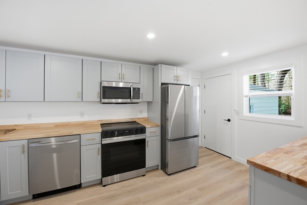 309 Pleasant Street Paxton, MA 01612 - Photo 17 of 27 a kitchen with a refrigerator stove and microwave