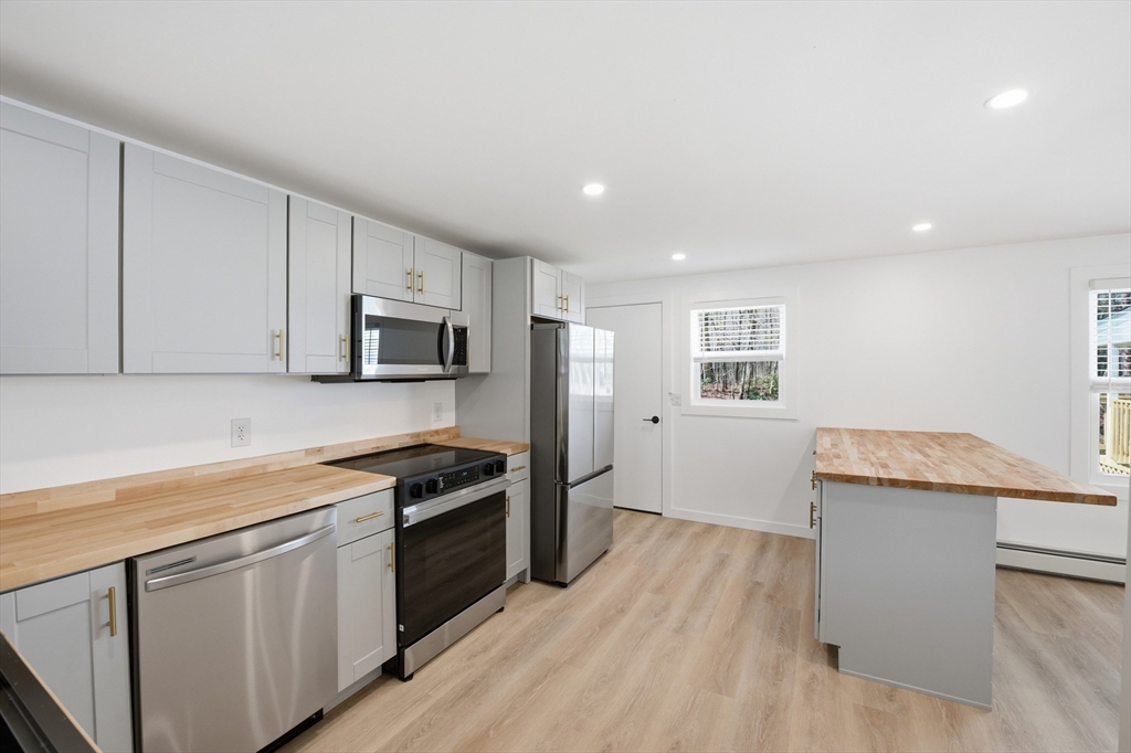 309 Pleasant Street Paxton, MA 01612 - Photo 18 of 27 a kitchen with granite countertop appliances cabinets and a wooden floor