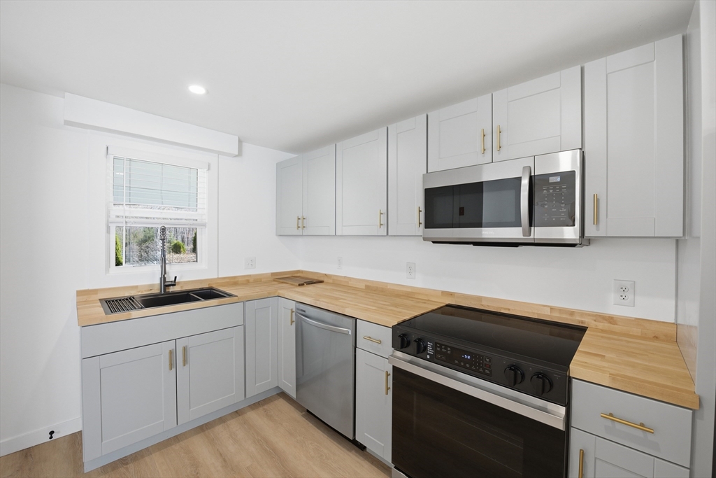 309 Pleasant Street Paxton, MA 01612 - Photo 20 of 27 a kitchen with a sink stove and microwave