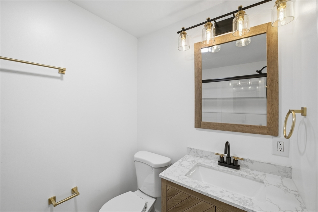 309 Pleasant Street Paxton, MA 01612 - Photo 7 of 27 a bathroom with a granite countertop sink vanity mirror and toilet