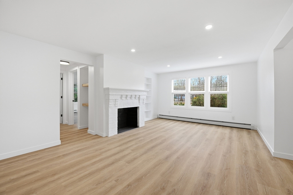 309 Pleasant Street Paxton, MA 01612 - Photo 10 of 27 a view of empty room with wooden floor and fireplace